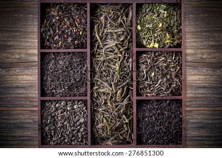 Assortment of dry tea leaves in wooden crate