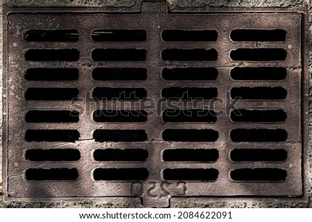 Metal old rusty sewer grate, sanitary hatch built into the asphalt Stock fotó © 