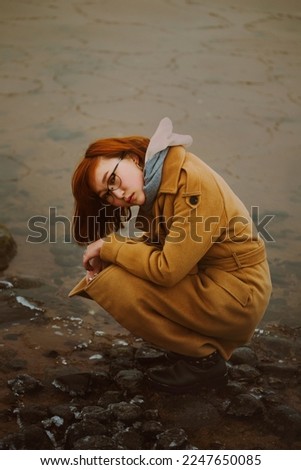 Similar – Image, Stock Photo Woman on stony seashore looking on foamy water washing peaks