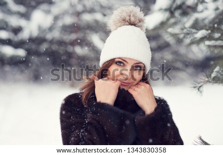 Beautiful Young Girl In A Winter Knitted Hat With A Pompon Closeup Portrait Of A Beautiful Young Girl In A Winter Knitted Hat With A Pompon Closeup Portrait Of A