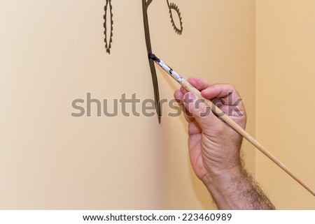 painter\'s hand while decorating