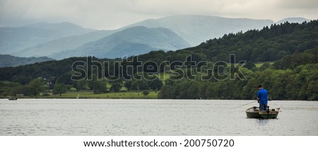 Windermere, England  - June 14: Small boats on lake Windermere, on June 14, 2014, in Windermere, Lake District, England. Windermere is the largest natural lake in England.