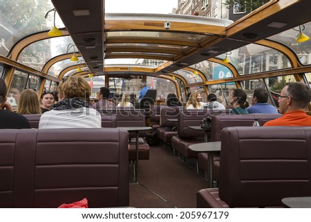 Amsterdam, Netherlands - June 30: Unidentified people on a cruise at the water canals of Amsterdam, Netherlands, on June 30, 2014.