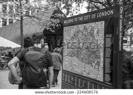 London, England - October 15: Tourists looking at a map of the City of London in London, England on October 15, 2014.