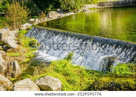 flowing of the water of the Sorgue river in Fontaine de Vaucluse village in Provence, France on a summer day Stok fotoğraf © 