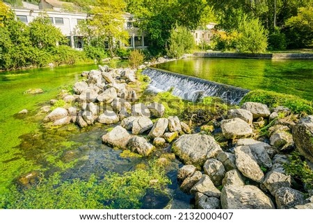 Sorgue river flowing along the Fontaine de Vaucluse village in Provence, France on a summer day Stok fotoğraf © 