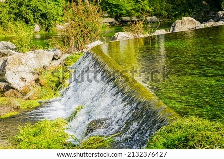 flowing of the water of the Sorgue river in Fontaine de Vaucluse village in Provence, France on a summer day Stok fotoğraf © 