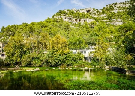 Sorgue river and limestone mountains in Fontaine de Vaucluse village in Provence, France on a summer day Stok fotoğraf © 