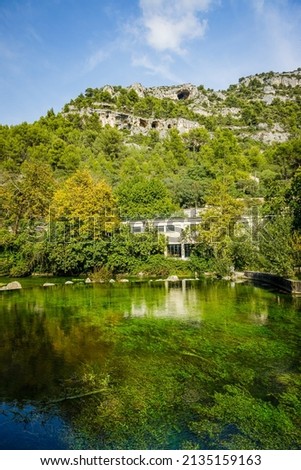 limestone mountains  and Sorgue river in Fontaine de Vaucluse village in Provence, France on a summer day Stok fotoğraf © 