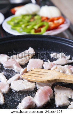 cooking chicken, red paprika, green paprika in the kitchen