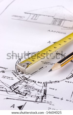 The point of a measuring tape and pencil on a technical drawing