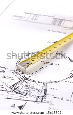 Yellow measuring tape on a builders plan