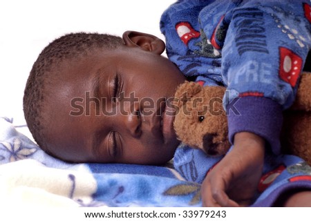 Sick little boy sleeping with his teddy bear