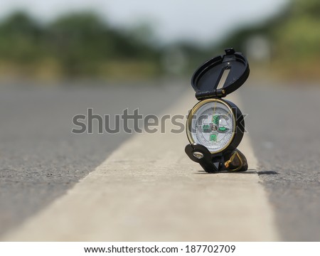 Compass on the road , Blur background in the area of confusion