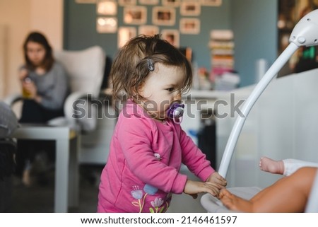 Similar – Image, Stock Photo Baby playing alone with toys on a carpet on the floor at home