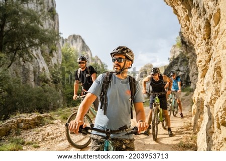 Similar – Image, Stock Photo Young man riding ebike in the park