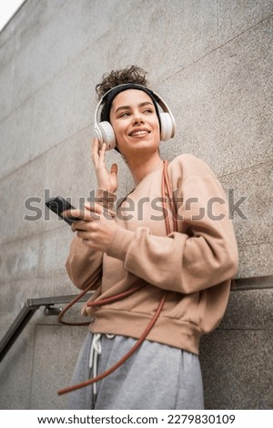 Similar – Image, Stock Photo Sportive woman in headphones using social media on smartphone