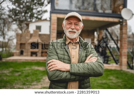 Similar – Image, Stock Photo Man standing in front of a wind turbine