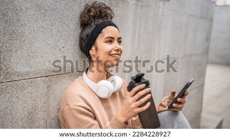 Similar – Image, Stock Photo Sportive woman in headphones using social media on smartphone