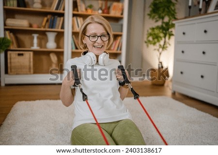 Similar – Image, Stock Photo Woman with resistance band on wrists working out at home