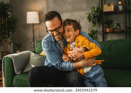 Similar – Image, Stock Photo Parents laughing and having fun with their baby son sitting at the home terrace, with beautiful sunset light.