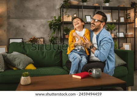 Similar – Image, Stock Photo Father and son reading book together