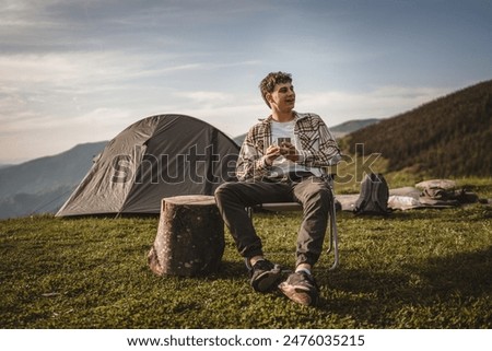 Similar – Image, Stock Photo Boy sitting on a sofa with headphones on his head and using the laptop