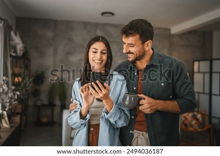 Similar – Foto Bild bei schlechtem Wetter ein Handy benutzen