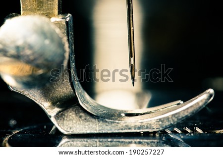 The needle of an old, vintage, retro sewing machine on a black background