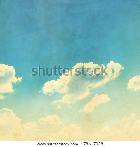 Blue sky with sparse clouds in grunge style.
