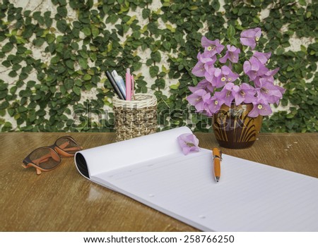 Pen Box, notebook, glasses and vase in wood table