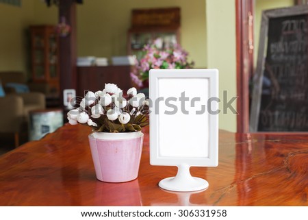 Menu frame and flower pots on Table in Bar restaurant cafe