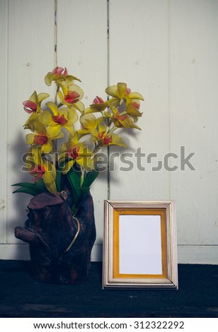 Frame on a wooden table, Still Life.