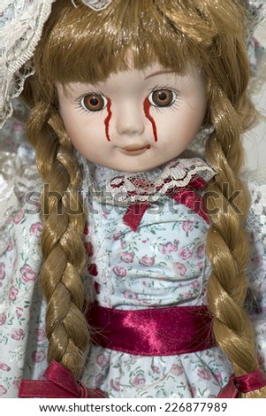 Sad doll weeping blood tears