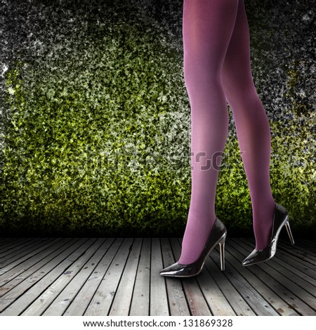 Woman\'s Legs Wearing Pantyhose and High Heels in empty room
