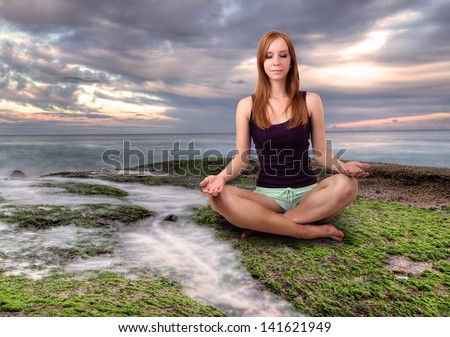 Girl meditating at the calm place