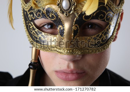 Elegant girl with a wonderful mask studio shot