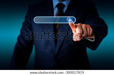 Torso of businessman pushing forward his left hand to touch a magnifier icon in a virtual search bar with his index finger. Do place your text into the empty search box. Background with copy space.