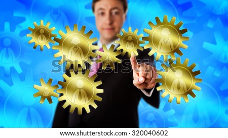 Happy manager touching a gear train made of eight cog wheels. Each cog is embossed with a white collar worker icon, either male or female. Concept for the mechanics of team work and gender equality.