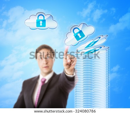Authorized looking white collar worker is stacking up encrypted cloud objects forming a secure storage tower. Technology metaphor for cloud security, remote data storage and digital risk mitigation.