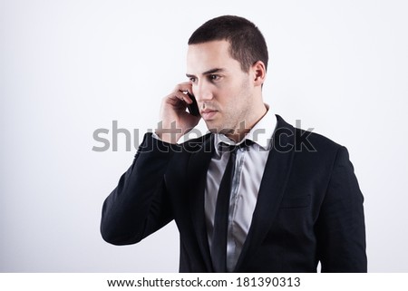 Elegant and modern business man talking on his phone about his company and profit increase.