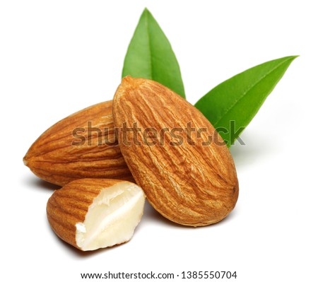 Group of almonds with leaves isolated on white background