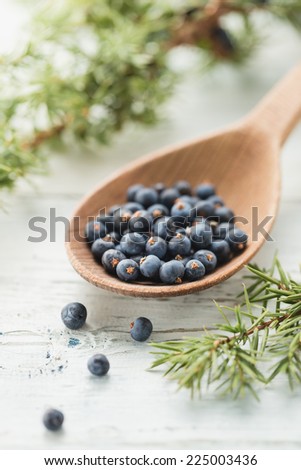 Wooden spoon with juniper berries