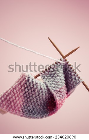 Close up of knitted yarn with a pair of knitting needles