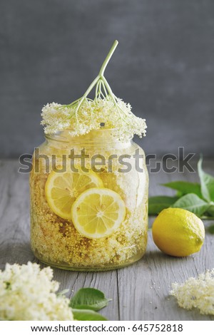 Similar – Image, Stock Photo Elder flower syrup ingredients: Elder branch, lemon and sugar in glass jar