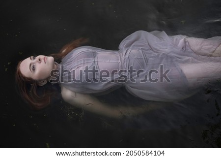 Similar – Image, Stock Photo Redhead fairytale female mermaid swimming underwater