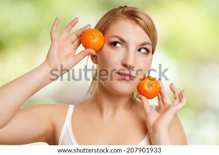 Woman with two tangerines