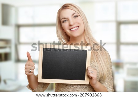 Close-up of a young woman showing thumbs up