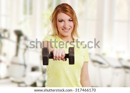 woman during strength training with dumbbell