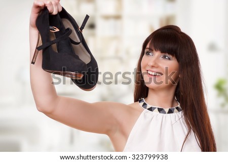 Woman holding shoes